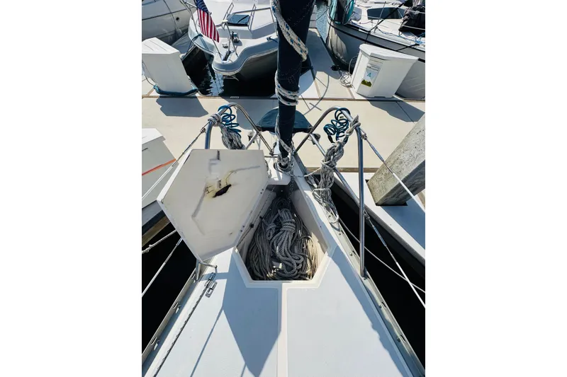 Slide: The Image of Cockpit view of 1989 Hunter Legend 37 sailboat, featuring steering wheel and nautical equipment. - 23