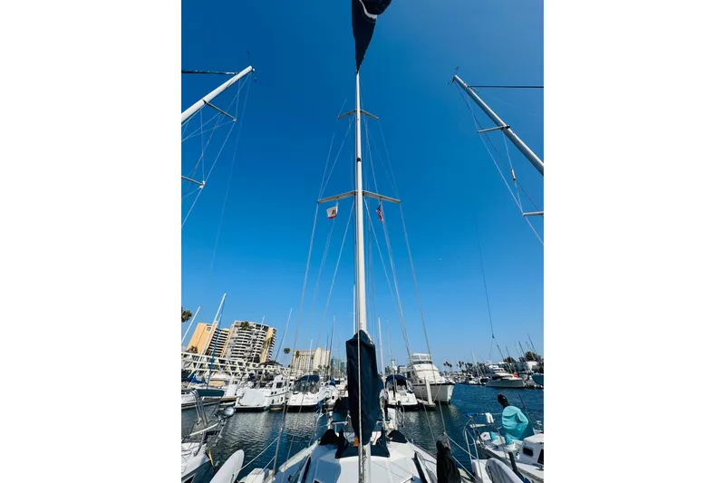 Slide: The Image of 1989 Hunter Legend 37 sailboat docked at marina, view of cockpit and surrounding boats. - 24