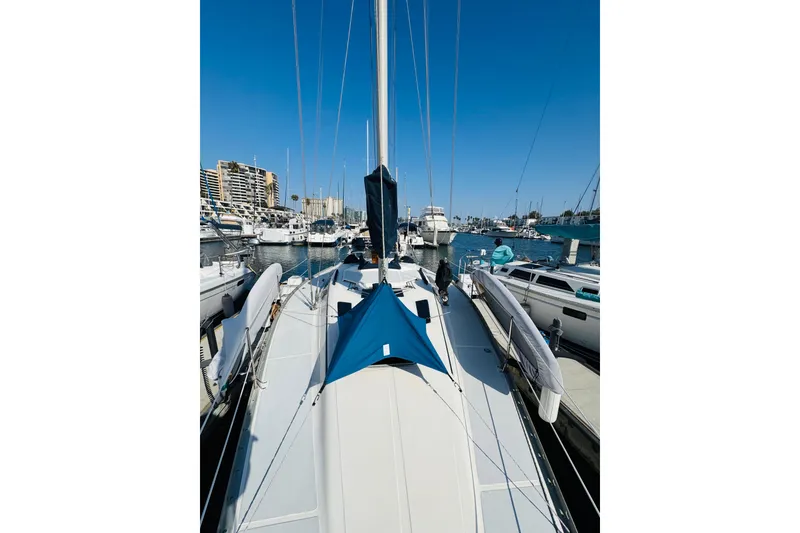 Slide: The Image of 1989 Hunter Legend 37 sailboat docked in a marina, showcasing deck and rigging. - 25