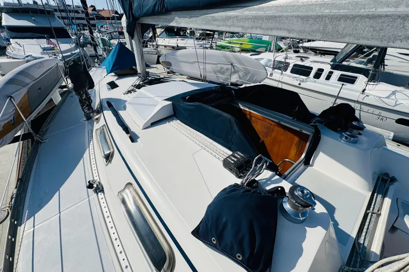 Slide: The Image of 1989 Hunter Legend 37 sailboat docked in a marina under clear blue skies. - 29