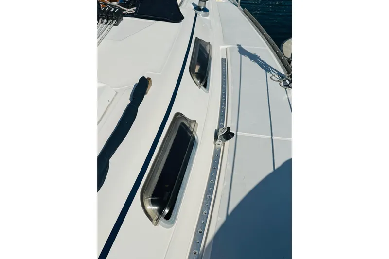 Slide: The Image of 1989 Hunter Legend 37 sailboat deck with ropes and fittings, docked at marina. - 30