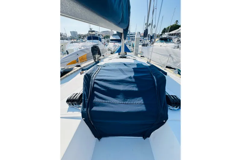 Slide: The Image of 1989 Hunter Legend 37 sailboat docked, featuring a sleek deck and rigging. - 31