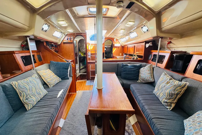 Slide: The Image of 1989 Hunter Legend 37 sailboat docked at marina, showcasing deck and winches. - 32