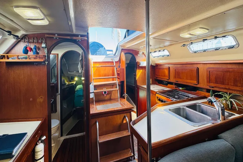 Slide: The Image of Sail of 1990 Hunter Legend 37 yacht against clear blue sky. - 35