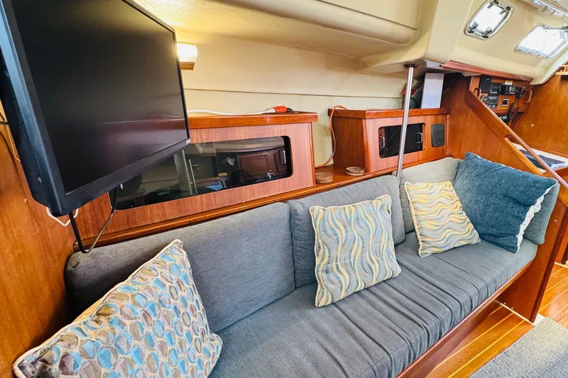 Slide: The Image of Navigation station of 1989 Hunter Legend 37 sailboat with control panel and notebook. - 42