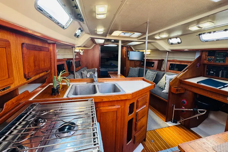 Slide: The Image of Navigation station of 1989 Hunter Legend 37 sailboat with control panels and notebook. - 43