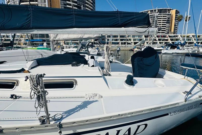 Slide: The Image of 1989 Hunter Legend 37 sailboat docked in a marina under clear blue skies. - 5