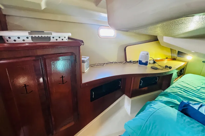 Slide: The Image of Interior of 1989 Hunter Legend 37 sailboat, featuring a compact bathroom and cozy cabin area. - 53