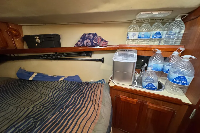 Slide: The Image of Cozy cabin interior of 1989 Hunter Legend 37 sailboat with wooden cabinets and bedding. - 58