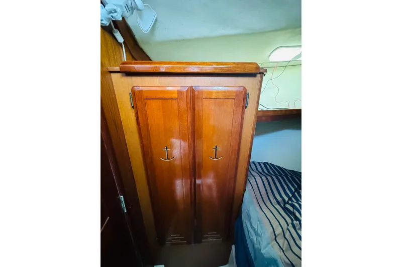 Slide: The Image of Wooden cabinet with anchor handles inside 1989 Hunter Legend 37 sailboat cabin. - 59