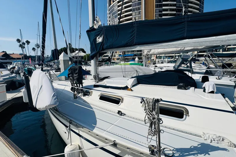 Slide: The Image of 1989 Hunter Legend 37 sailboat docked at marina under clear blue sky. - 6