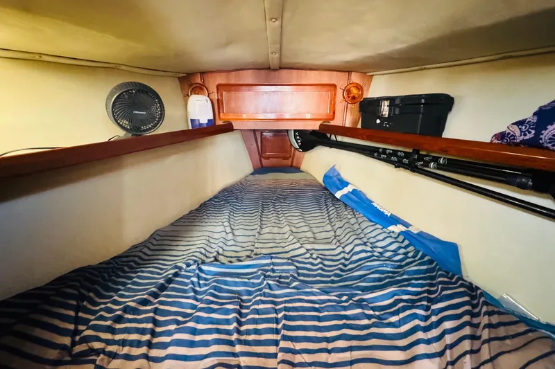 Slide: The Image of Cozy cabin interior of 1989 Hunter Legend 37 sailboat with striped bedding. - 60