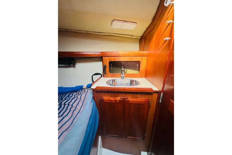 Slide: The Image of Interior of 1989 Hunter Legend 37 sailboat with wooden cabinetry and compact sink. - 62