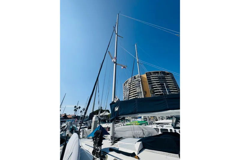 Slide: The Image of 1989 Hunter Legend 37 sailboat docked in a marina under clear blue skies. - 7