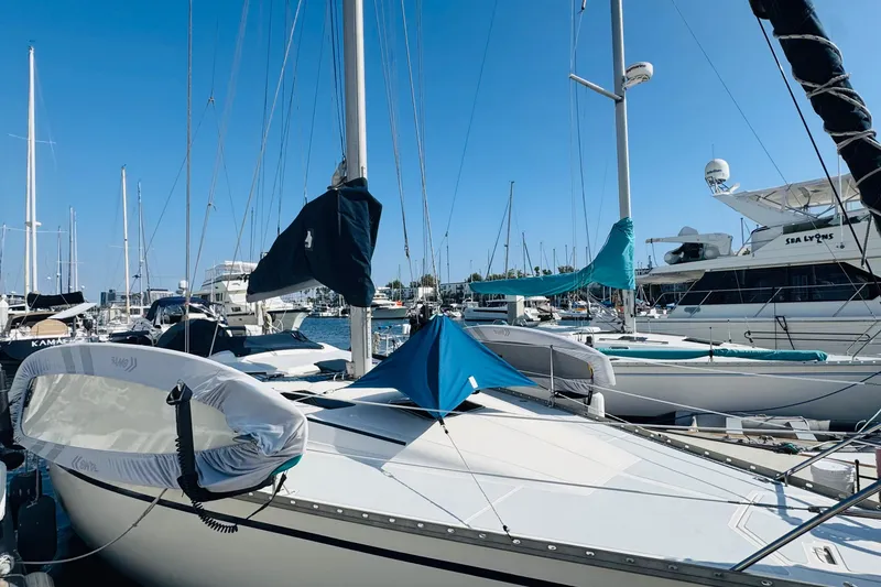Slide: The Image of 1989 Hunter Legend 37 sailboat docked in marina, surrounded by modern buildings. - 9