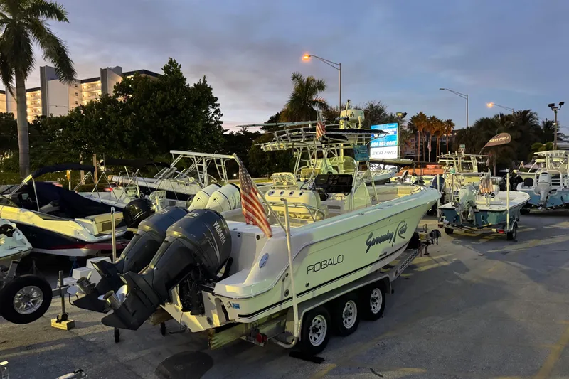 Slide: The Image of 2004 Robalo R260 Center Console boat with Garmin radar under a clear blue sky. - 10