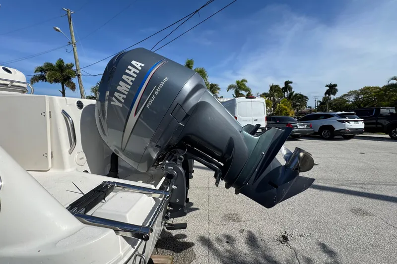 Slide: The Image of 2004 Robalo R260 Center Console storage compartment with open hatch and latch. - 18