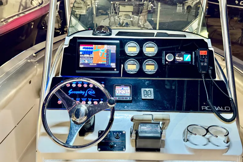 Slide: The Image of 2004 Robalo R260 Center Console boat interior with seating and Yamaha engines. - 20