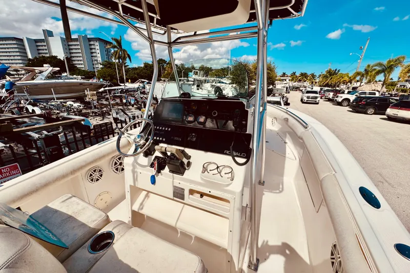 Slide: The Image of 2004 Robalo R260 Center Console storage compartment being opened. - 21