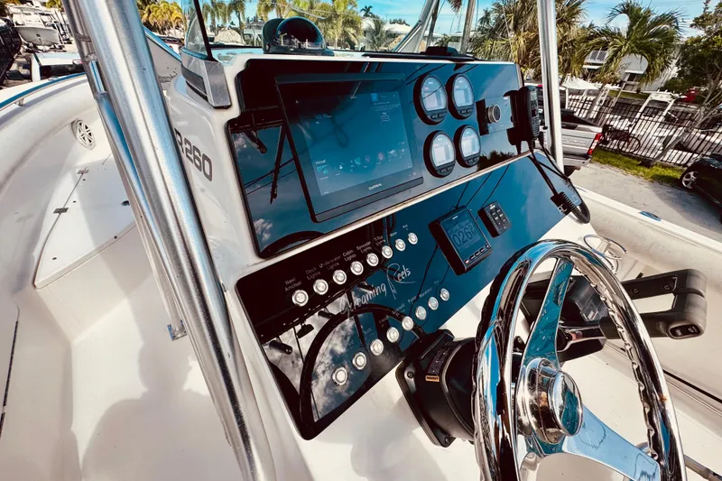 Slide: The Image of 2004 Robalo R260 Center Console boat interior with seating and console details. - 22