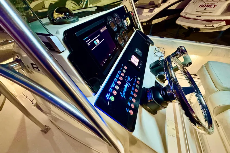 Slide: The Image of 2004 Robalo R260 Center Console boat with cooler and stainless steel railings. - 23