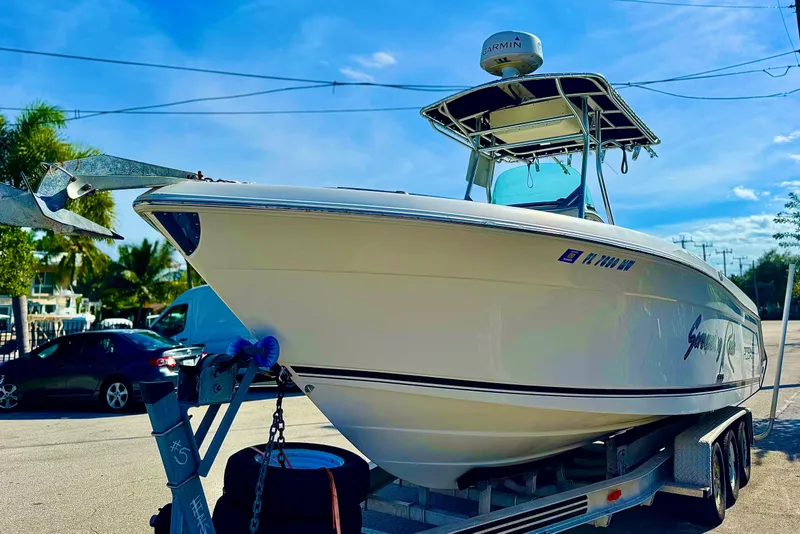 Slide: The Image of 2004 Robalo R260 Center Console boat with Complete Marine sign on seat. - 25