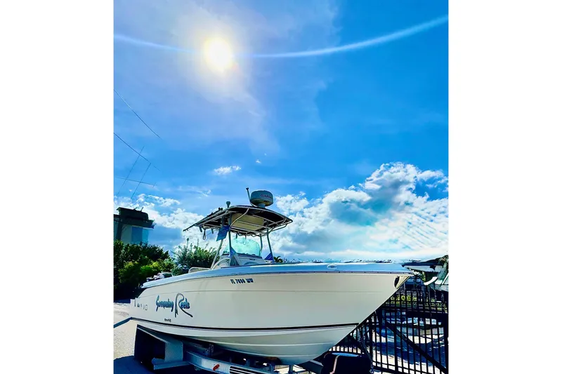Slide: The Image of 2004 Robalo R260 Center Console boat interior with Complete Marine sign. - 27