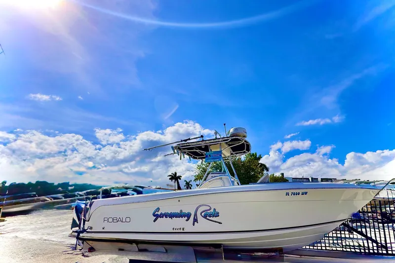 Slide: The Image of 2004 Robalo R260 Center Console boat with steering wheel and control panel. - 29