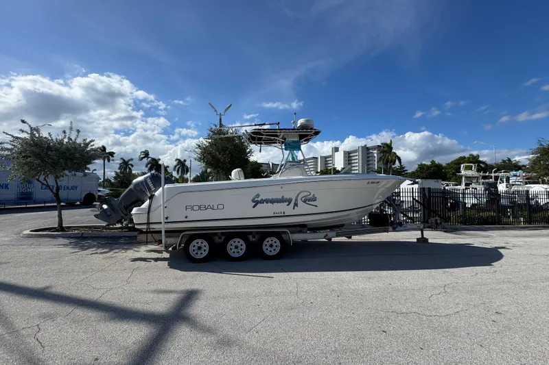 Slide: The Image of 2004 Robalo R260 Center Console boat dashboard with steering wheel and navigation controls. - 31