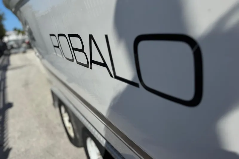 Slide: The Image of 2004 Robalo R260 Center Console boat dashboard with steering wheel and control panel. - 39