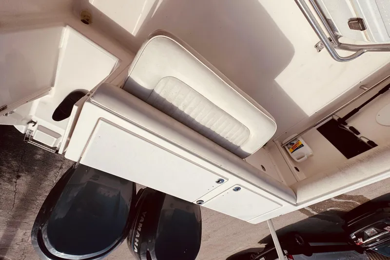 Slide: The Image of 2004 Robalo R260 Center Console boat at marina during evening. - 45