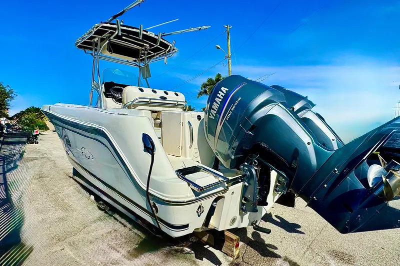 Slide: The Image of 2004 Robalo R260 Center Console with Yamaha outboard motor in a sunny parking lot. - 6