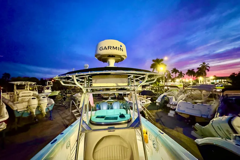 Slide: The Image of 2004 Robalo R260 Center Console boat under a bright blue sky. - 8