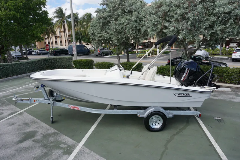 The Image of 2026 Boston Whaler 160 Super Sport boat on trailer in parking lot. - 0