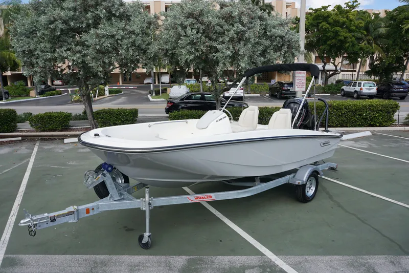 Slide: The Image of 2026 Boston Whaler 160 Super Sport boat on trailer in parking lot. - 1
