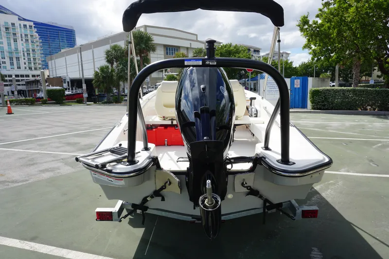 Slide: The Image of 2026 Boston Whaler 160 Super Sport boat in a parking lot, rear view. - 10