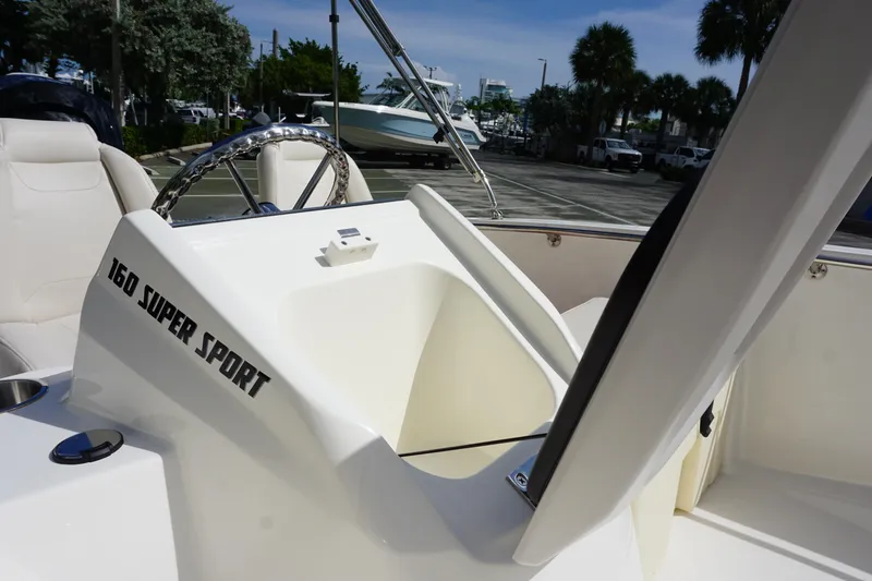 Slide: The Image of 2026 Boston Whaler 160 Super Sport boat interior with open storage compartment. - 11