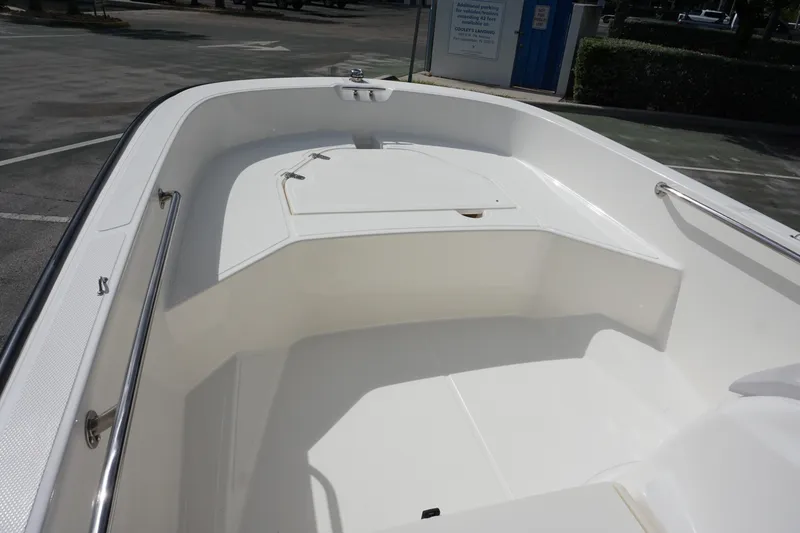 Slide: The Image of 2026 Boston Whaler 160 Super Sport boat interior with white seating and storage compartment. - 13