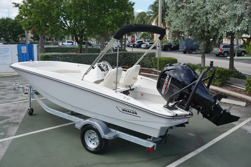 Slide: The Image of 2026 Boston Whaler 160 Super Sport boat on trailer in parking lot. - 2