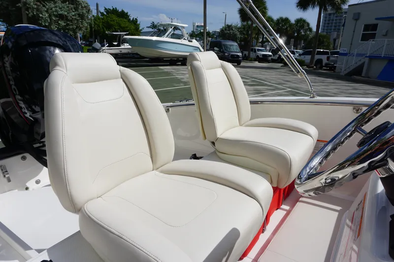 Slide: The Image of 2026 Boston Whaler 160 Super Sport boat with white leather seats and steering wheel. - 5