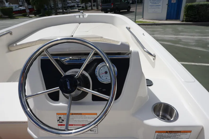 Slide: The Image of 2026 Boston Whaler 160 Super Sport steering wheel and dashboard, featuring a sleek design. - 6