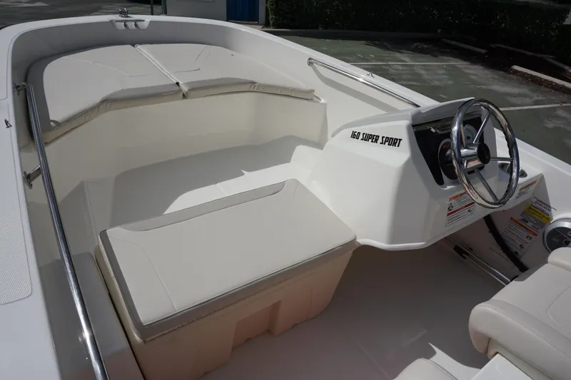 Slide: The Image of 2026 Boston Whaler 160 Super Sport interior with steering wheel and seating. - 7