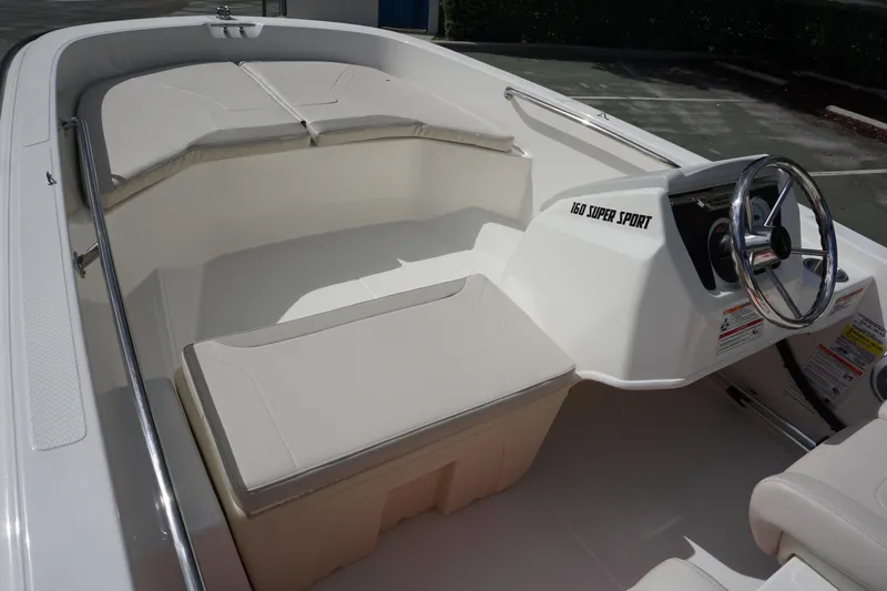 Slide: The Image of 2026 Boston Whaler 160 Super Sport interior with steering wheel and seating. - 8
