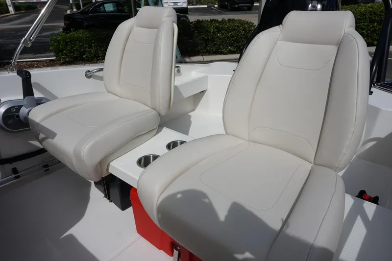 Slide: The Image of 2026 Boston Whaler 160 Super Sport interior with white leather seats and cup holders. - 9