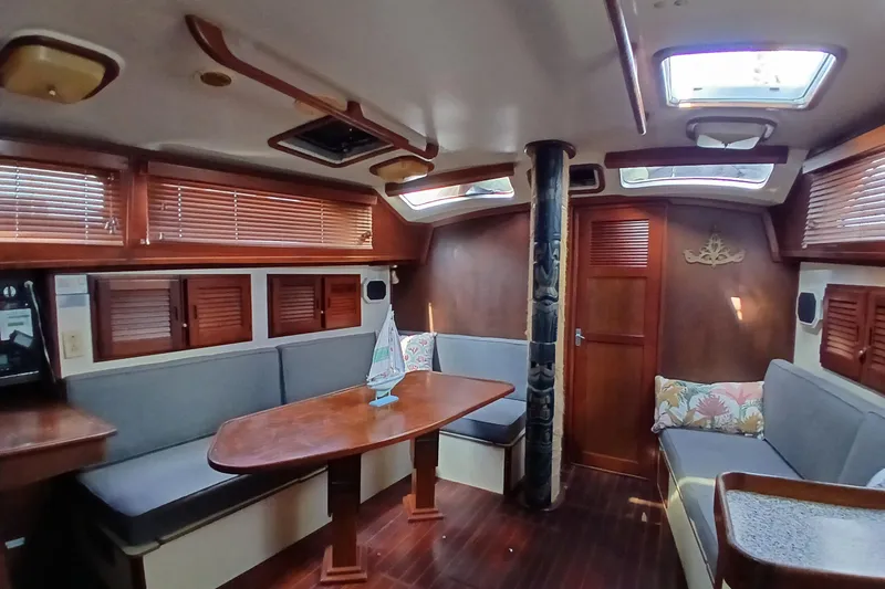 Slide: The Image of Interior of 1986 Irwin 43 sailboat with wooden furnishings and cozy seating area. - 11