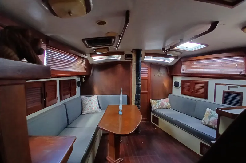 Slide: The Image of Interior of 1986 Irwin 43 sailboat with wooden furnishings and cozy seating area. - 13