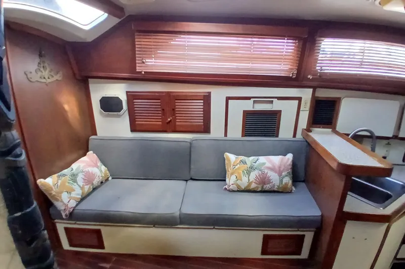 Slide: The Image of Interior of 1986 Irwin 43 sailboat with cozy seating and floral cushions. - 14