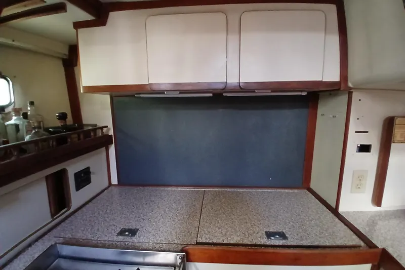 Slide: The Image of 1986 Irwin 43 yacht kitchen with wooden cabinets and countertop. - 16