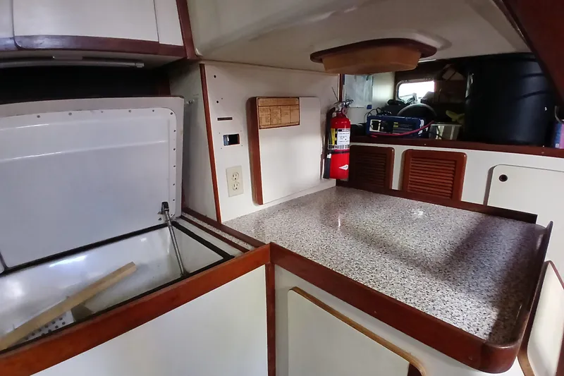 Slide: The Image of 1986 Irwin 43 yacht interior with countertop, storage, and fire extinguisher. - 19