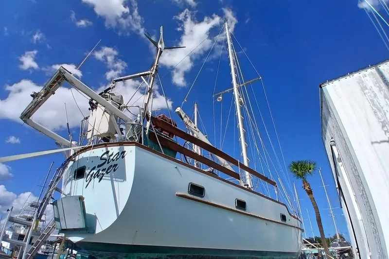 Slide: The Image of 1986 Irwin 43 sailboat "Star Gazer" docked under a vibrant blue sky. - 26
